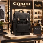 Coatch Black Leather Charter Backpack with Dual Buckle Closures & Front Utility Pocket (058)