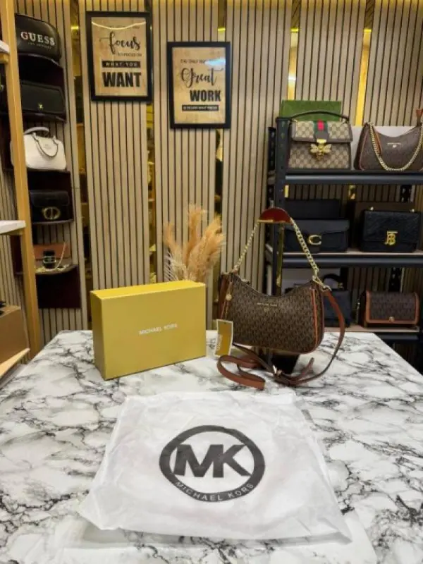 1e2d5d9b-6a7c-4f12-9fb2-ceb7933eec8f.webp Michael Korrs Jet Set Charm Logo Sling Bag With Box And Dust Bag (4018-Brown) - Image 1