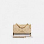 coac Klare handbag Crossbody in Blocked Signature Canvas With folding 190